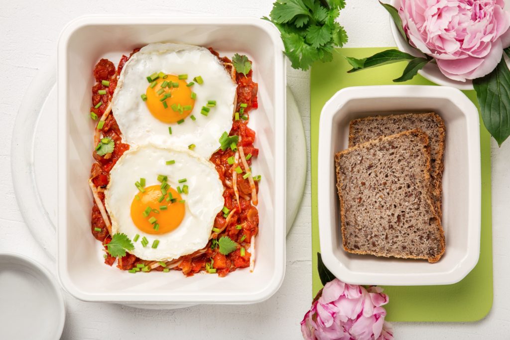 Jajka w pomidorach z papryką, kiełkami fasoli mung i kolendrą z domowych chlebem gryczanym